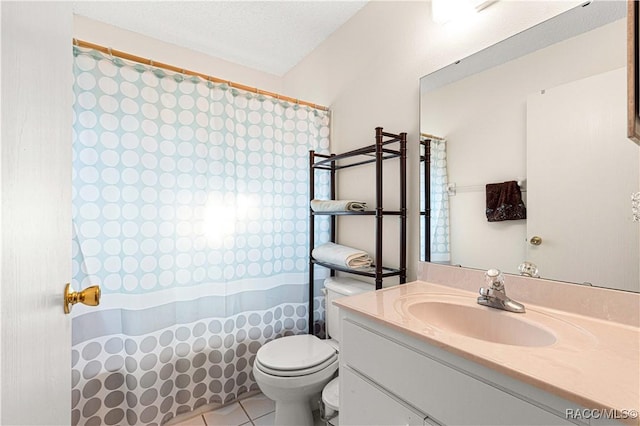 bathroom with tile patterned flooring, vanity, a textured ceiling, and toilet