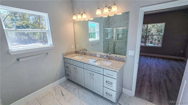 bathroom with vanity and a shower with door