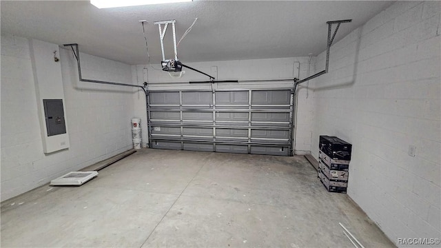 garage featuring a garage door opener and electric panel