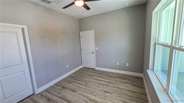 empty room featuring ceiling fan and light wood-type flooring