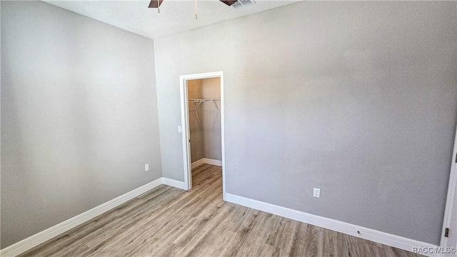 spare room featuring ceiling fan and light hardwood / wood-style floors