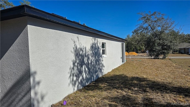 view of property exterior with a yard