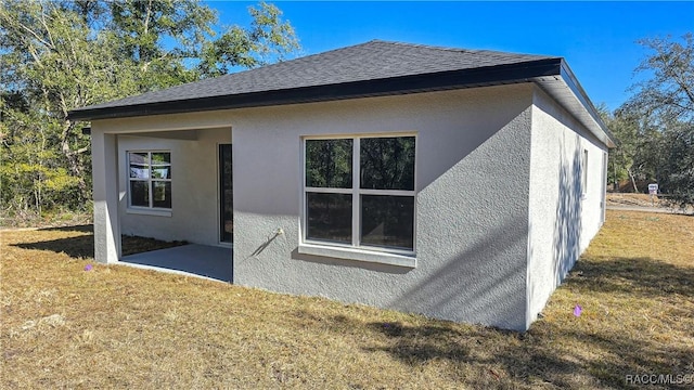 view of side of home featuring a lawn