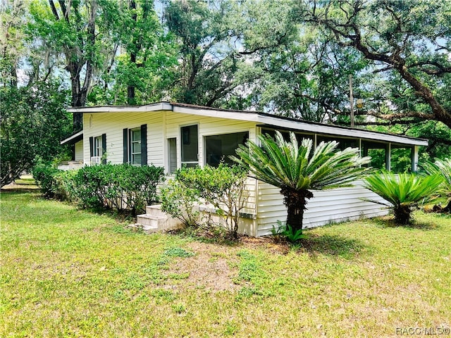 view of side of home featuring a yard