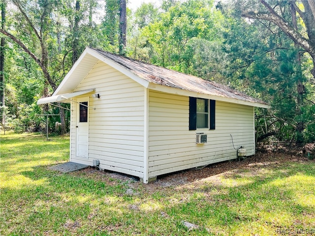 view of outbuilding with a lawn