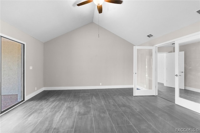 unfurnished living room with french doors, dark hardwood / wood-style floors, vaulted ceiling, and ceiling fan