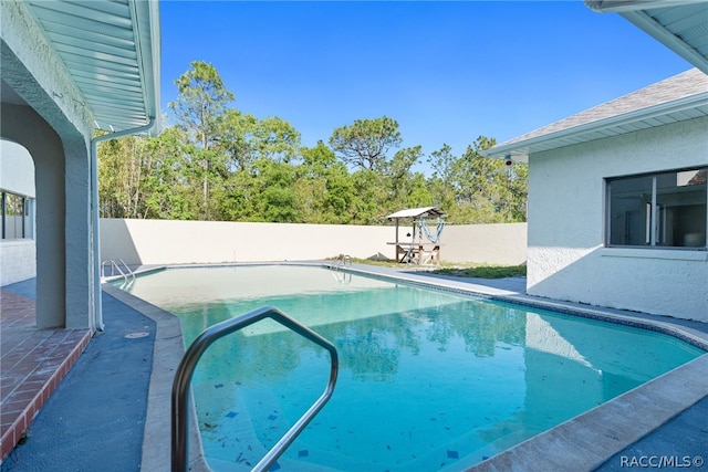 view of swimming pool with a patio