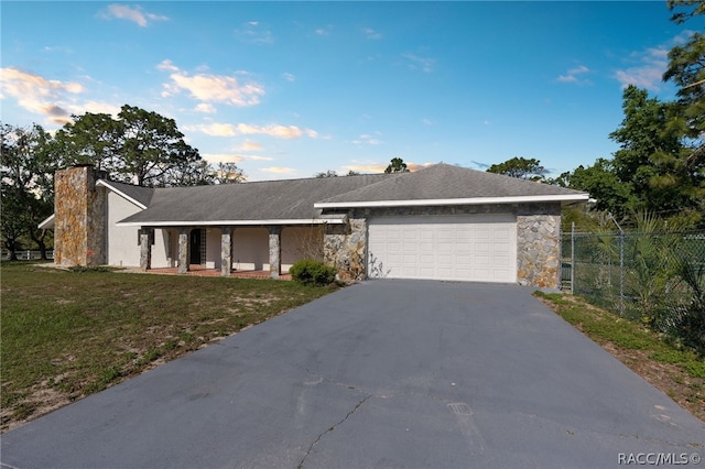 ranch-style home with a front yard and a garage