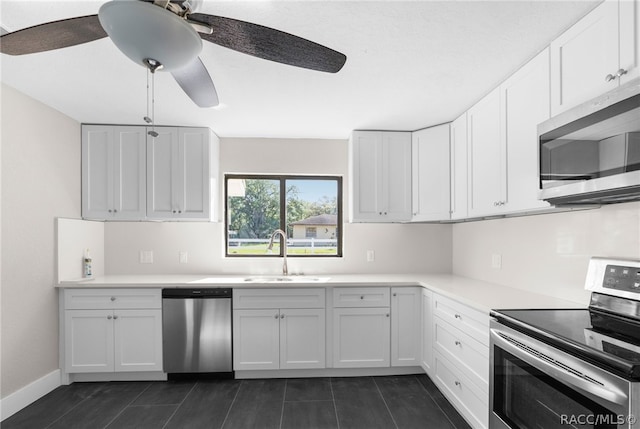 kitchen with white cabinetry, sink, ceiling fan, and stainless steel appliances