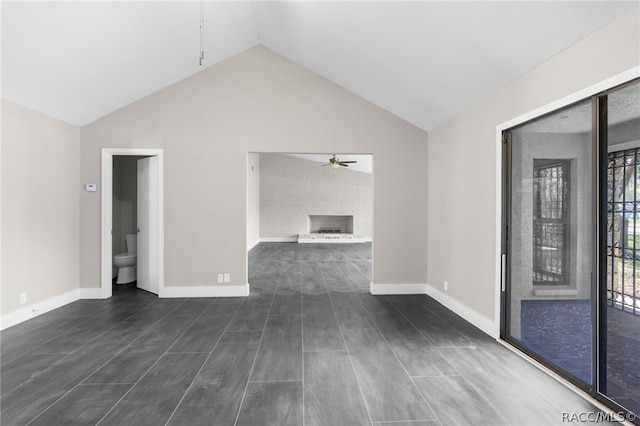 interior space with ceiling fan, dark wood-type flooring, and lofted ceiling