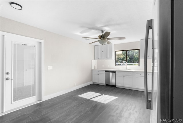 kitchen featuring white cabinets, sink, dark hardwood / wood-style floors, ceiling fan, and stainless steel appliances