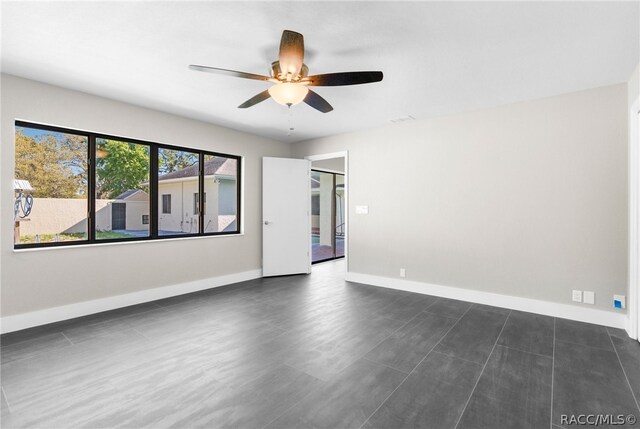 unfurnished room with ceiling fan and dark hardwood / wood-style flooring