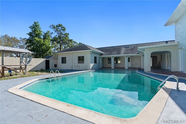 view of swimming pool with a patio