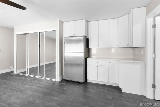 kitchen featuring white cabinetry, stainless steel fridge, and ceiling fan