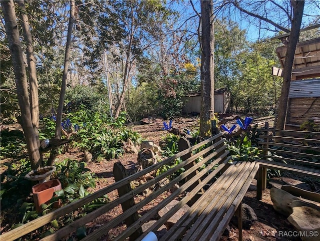 wooden terrace with a storage shed