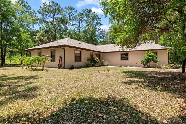 7634 N Hargrove Pt, Crystal River, FL 34428 - view of front of home featuring a front yard and stucco siding