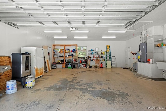 7634 N Hargrove Pt, Crystal River, FL 34428 - garage featuring freestanding refrigerator, stainless steel fridge, a garage door opener, and heating unit