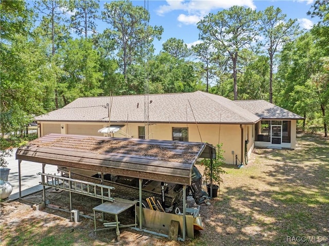 7634 N Hargrove Pt, Crystal River, FL 34428 - back of house with a sunroom, stucco siding, a deck, and view of scattered trees