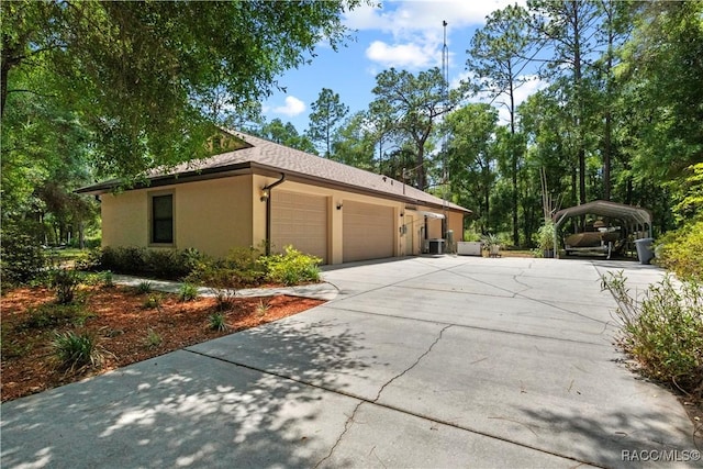 7634 N Hargrove Pt, Crystal River, FL 34428 - view of property exterior featuring stucco siding, an attached garage, concrete driveway, and a carport