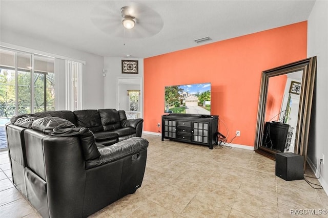 living room featuring light tile patterned flooring and ceiling fan