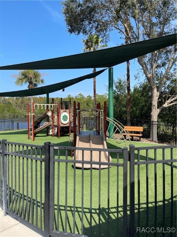 view of jungle gym featuring a lawn