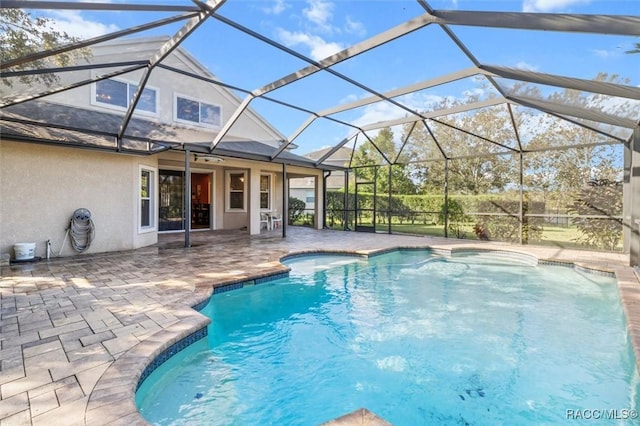 view of pool with a lanai and a patio