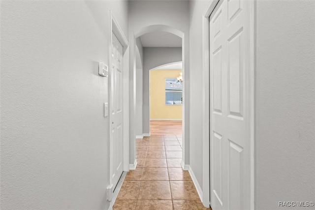 corridor with light tile patterned floors