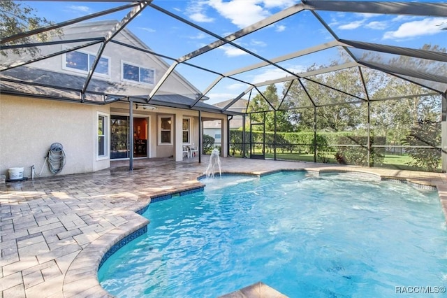 view of swimming pool featuring a lanai and a patio