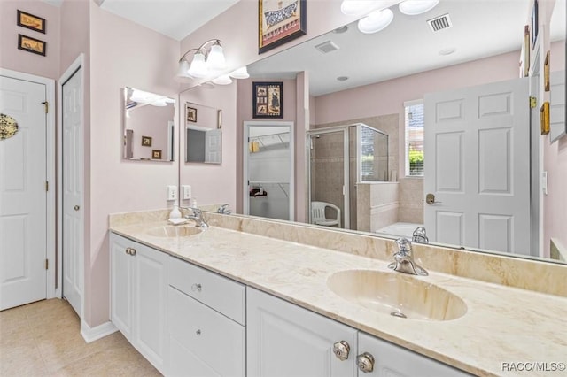 bathroom featuring tile patterned floors, separate shower and tub, and vanity