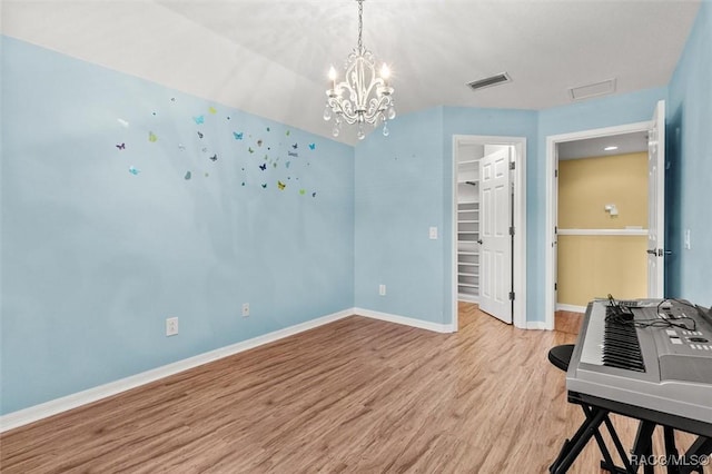 interior space with light hardwood / wood-style flooring and a chandelier