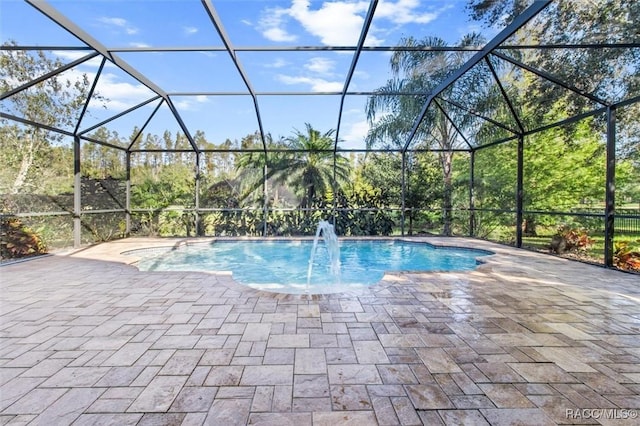 view of pool with pool water feature, a lanai, and a patio area