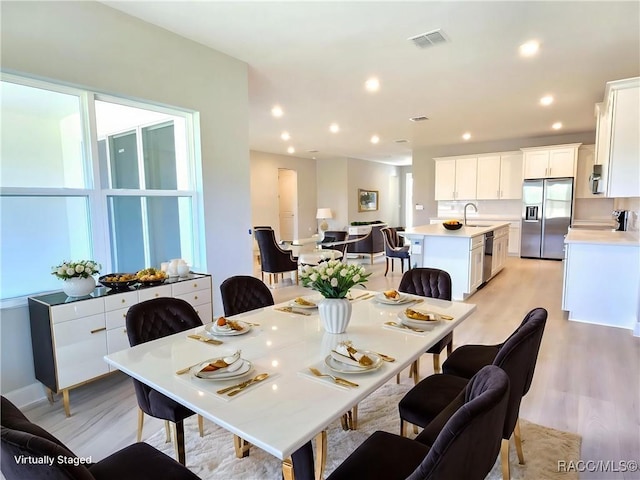 814 E Bismark St, Hernando, FL 34442 - dining space with light wood-style floors and recessed lighting