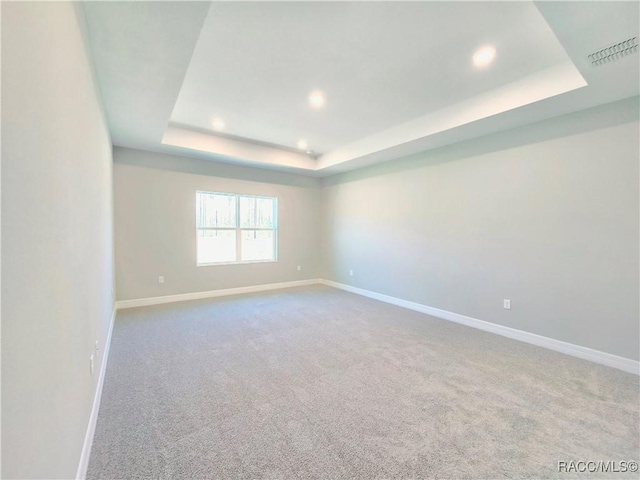 814 E Bismark St, Hernando, FL 34442 - empty room with a raised ceiling, recessed lighting, baseboards, and carpet flooring
