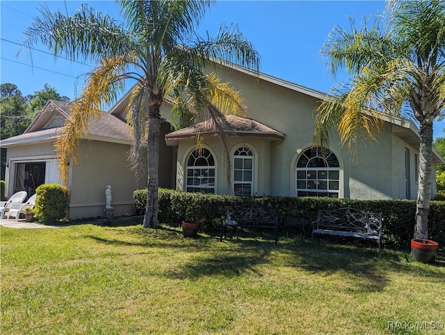 mediterranean / spanish-style house featuring a front yard