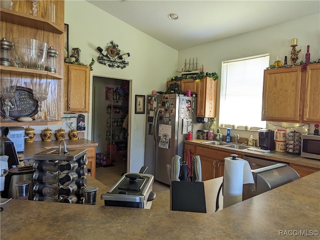 kitchen featuring stainless steel appliances, lofted ceiling, and sink