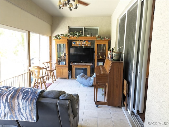 living room featuring ceiling fan and light tile patterned flooring