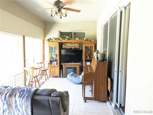 tiled living room with ceiling fan