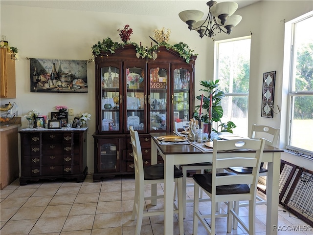 tiled dining area with an inviting chandelier