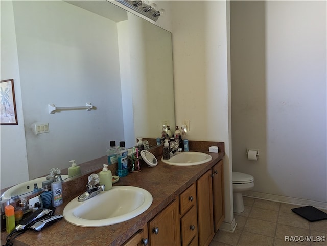 bathroom with tile patterned flooring, vanity, and toilet