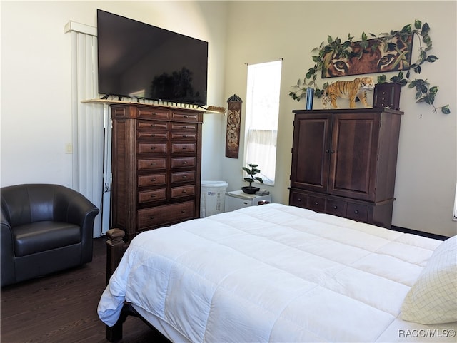 bedroom with dark hardwood / wood-style flooring