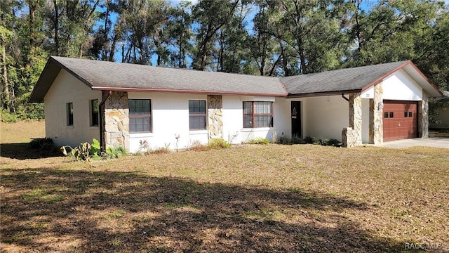 single story home featuring a garage and a front yard