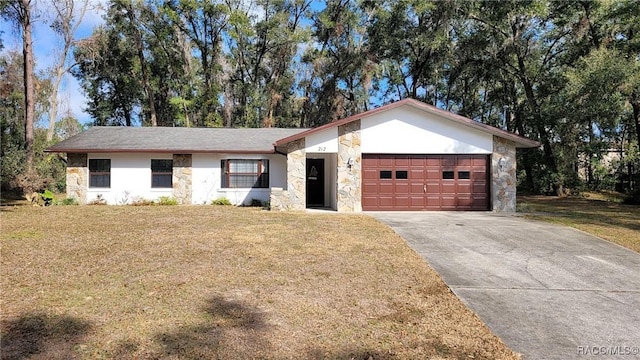 ranch-style home featuring a garage and a front lawn