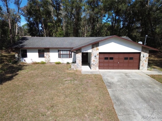 ranch-style house featuring a garage and a front lawn