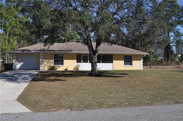 ranch-style house featuring a garage and a front yard