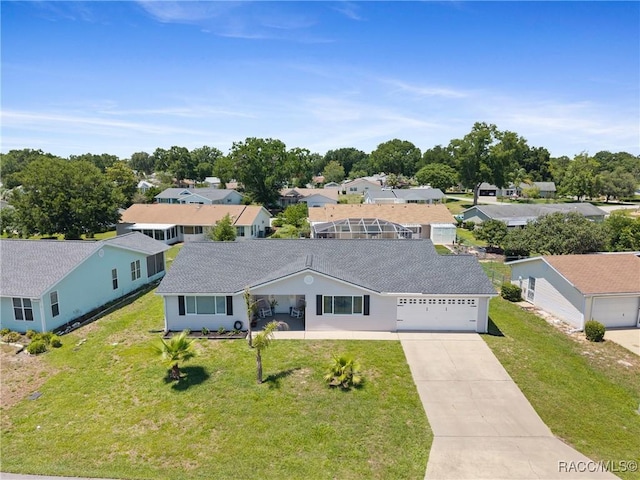 8849 SW 116th Place Rd, Ocala, FL 34481 - view of front of property featuring concrete driveway, an attached garage, a front lawn, a residential view, and roof with shingles