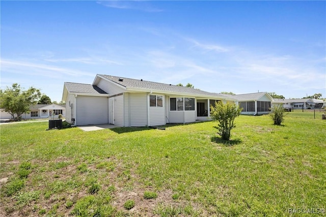 8849 SW 116th Place Rd, Ocala, FL 34481 - rear view of property featuring a lawn and a sunroom