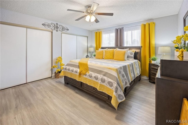 8849 SW 116th Place Rd, Ocala, FL 34481 - bedroom with multiple closets, wood finished floors, a textured ceiling, and ceiling fan
