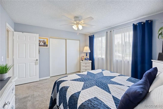8849 SW 116th Place Rd, Ocala, FL 34481 - bedroom featuring carpet, a closet, ceiling fan, and a textured ceiling