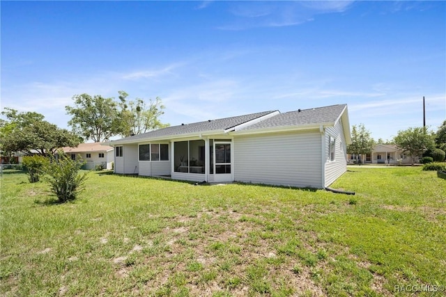 8849 SW 116th Place Rd, Ocala, FL 34481 - rear view of house with a lawn and a sunroom