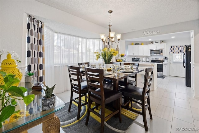 8849 SW 116th Place Rd, Ocala, FL 34481 - dining room with a chandelier, a textured ceiling, and light tile patterned floors